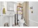 Bright bathroom featuring modern fixtures, a shower/tub combination with white tiling, and a tall shelving at 2382 Waverly Rd., Pawleys Island, SC 29585