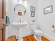 Stylish half bathroom with pedestal sink, designer mirror, and elegant fixtures at 2382 Waverly Rd., Pawleys Island, SC 29585