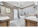 Modern bathroom featuring a freestanding tub, dual vanities, and elegant tile work at 2382 Waverly Rd., Pawleys Island, SC 29585