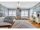 Bright bedroom with floral wall art, a vanity area, large windows, and a colorful rug at 2382 Waverly Rd., Pawleys Island, SC 29585