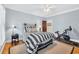 Comfortable bedroom with striped bedding, wood floors, a ceiling fan, and dedicated workout area at 2382 Waverly Rd., Pawleys Island, SC 29585