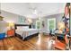 Spacious bedroom with hardwood floors and a comfortable bed with nightstands and wall art at 2382 Waverly Rd., Pawleys Island, SC 29585