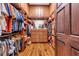 Walk-in closet with custom shelving and hardwood floors at 2382 Waverly Rd., Pawleys Island, SC 29585