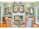 Chic dining room featuring a glass table, chandelier, fireplace, and decorative accents at 2382 Waverly Rd., Pawleys Island, SC 29585