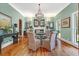 Elegant dining room featuring a crystal chandelier, fireplace, and hardwood floors ideal for dinner parties at 2382 Waverly Rd., Pawleys Island, SC 29585