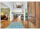 Grand foyer with soaring ceilings, hardwood floors, elegant staircase, and views to the pool beyond at 2382 Waverly Rd., Pawleys Island, SC 29585