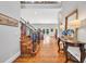 Elegant foyer featuring hardwood floors, staircase, table with flowers, and views to the outdoors at 2382 Waverly Rd., Pawleys Island, SC 29585