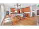 Charming kitchen area with built-in seating, wooden cabinets, and beautiful hardwood flooring at 2382 Waverly Rd., Pawleys Island, SC 29585
