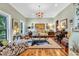 Cozy living room with neutral colors, hardwood floors, stylish furniture, and abundant natural light at 2382 Waverly Rd., Pawleys Island, SC 29585