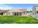 A well-maintained backyard showing ample lawn space and a screen porch at 2448 Whetstone Ln., Myrtle Beach, SC 29579