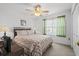 Relaxing bedroom with a decorative bed, ceiling fan, and natural light at 2448 Whetstone Ln., Myrtle Beach, SC 29579