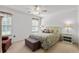 Cozy bedroom with floral bedding, a ceiling fan, bedside tables, and natural light at 2448 Whetstone Ln., Myrtle Beach, SC 29579