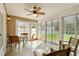 Bright sunroom features tile floors, neutral colors, fan and multiple windows overlooking the backyard at 2448 Whetstone Ln., Myrtle Beach, SC 29579