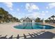 Community pool with plenty of lounge chairs, umbrellas, and a bath house at 2475 Blue Crane Circle # 106, Myrtle Beach, SC 29577
