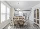 Bright dining area boasts wood floors, table and chairs, pendant lighting, and views of the kitchen at 2475 Blue Crane Circle # 106, Myrtle Beach, SC 29577