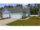 Stylish two-story home features a garage, manicured lawn, and welcoming pathway at 2475 Blue Crane Circle # 106, Myrtle Beach, SC 29577