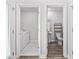 Hallway view of the laundry room and half bathroom with white walls at 2475 Blue Crane Circle # 106, Myrtle Beach, SC 29577