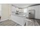 Stylish kitchen island with granite countertops, stainless steel appliances, and white cabinetry at 2475 Blue Crane Circle # 106, Myrtle Beach, SC 29577