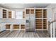 Spacious pantry storage with open white cabinets and stainless steel refrigerator in kitchen at 2475 Blue Crane Circle # 106, Myrtle Beach, SC 29577