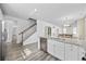 Kitchen island with stainless steel dishwasher and sink overlooking dining area and staircase at 2475 Blue Crane Circle # 106, Myrtle Beach, SC 29577
