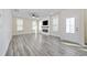 Sunlit living room boasts wood-look floors and a cozy fireplace feature at 2475 Blue Crane Circle # 106, Myrtle Beach, SC 29577