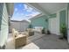 Staged covered patio with outdoor seating, rug, and plants, perfect for entertaining guests at 2475 Blue Crane Circle # 106, Myrtle Beach, SC 29577