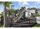 Fenced community playground with slides and other equipment with community bath house in background at 2475 Blue Crane Circle # 106, Myrtle Beach, SC 29577