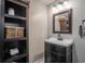 Cozy bathroom featuring dark vanity with white basin sink and open shelved storage unit at 2510 Redwood St., Georgetown, SC 29440