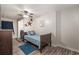 Bedroom with a ceiling fan, hardwood floors, a bed with blue comforter, and laundry adjacent at 2510 Redwood St., Georgetown, SC 29440