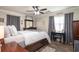 Cozy bedroom with neutral walls, ceiling fan, wood-look floors, a large dresser and natural light at 2510 Redwood St., Georgetown, SC 29440