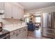 Open concept kitchen features stainless steel appliances and gray cabinets with a view into the living room at 2510 Redwood St., Georgetown, SC 29440