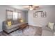 Living room with hardwood floors, a gray sofa with yellow throw pillows, and natural light at 2510 Redwood St., Georgetown, SC 29440