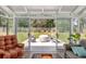 Enclosed sunroom leading to an outdoor patio with seating and a lush lawn at 2609 Seaport Circle, Georgetown, SC 29440