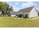Spacious backyard featuring a patio with outdoor seating and a view of the home's exterior at 2609 Seaport Circle, Georgetown, SC 29440