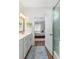 This bright bathroom leads to the primary bedroom with white vanity and glass shower enclosure at 2609 Seaport Circle, Georgetown, SC 29440