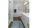 A clean bathroom with white cabinets, framed mirror, and a glass enclosed shower at 2609 Seaport Circle, Georgetown, SC 29440