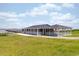 A view of the community clubhouse featuring waterfront access, green space, and a spacious fenced patio at 2609 Seaport Circle, Georgetown, SC 29440