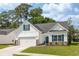 Inviting single-Gathering home featuring a manicured lawn, two-car garage, and stylish blue shutters at 2609 Seaport Circle, Georgetown, SC 29440