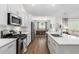 Bright kitchen with white cabinets, stainless appliances, and view into the dining area at 2609 Seaport Circle, Georgetown, SC 29440