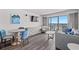 Cozy living room featuring comfortable seating, entertainment center, and sliding glass doors to the balcony at 3000 N Ocean Blvd. N # 531, Myrtle Beach, SC 29577