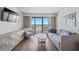 Inviting living room with modern furnishings, television, and sliding glass doors to the balcony at 3000 N Ocean Blvd. N # 531, Myrtle Beach, SC 29577