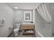 This modern bathroom has a tub shower, tile floors, and a well-lit vanity mirror at 3000 N Ocean Blvd. N # 708, Myrtle Beach, SC 29577