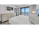 This bedroom features a flatscreen TV, balcony access, and a cool coastal aesthetic at 3000 N Ocean Blvd. N # 708, Myrtle Beach, SC 29577