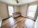 Well-lit bedroom featuring a couch and two windows with decorative curtains at 302 Silver Fox Trail, Myrtle Beach, SC 29588