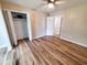 A bedroom with wood-grain flooring, ceiling fan, and walk-in closet at 302 Silver Fox Trail, Myrtle Beach, SC 29588