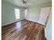 Light-filled bedroom with a ceiling fan, window and closet with wood-look flooring at 302 Silver Fox Trail, Myrtle Beach, SC 29588