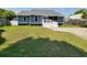 Charming single-story home featuring a screened-in porch and well-maintained front yard at 302 Silver Fox Trail, Myrtle Beach, SC 29588