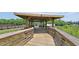 Wooden gazebo structure with a metal roof, overlooking a pond and natural landscape at 302 Silver Fox Trail, Myrtle Beach, SC 29588