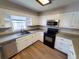 Efficient kitchen layout featuring modern appliances, white cabinets, and durable countertops at 302 Silver Fox Trail, Myrtle Beach, SC 29588