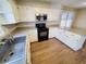Bright kitchen features white cabinets, stainless steel appliances, and updated countertops at 302 Silver Fox Trail, Myrtle Beach, SC 29588